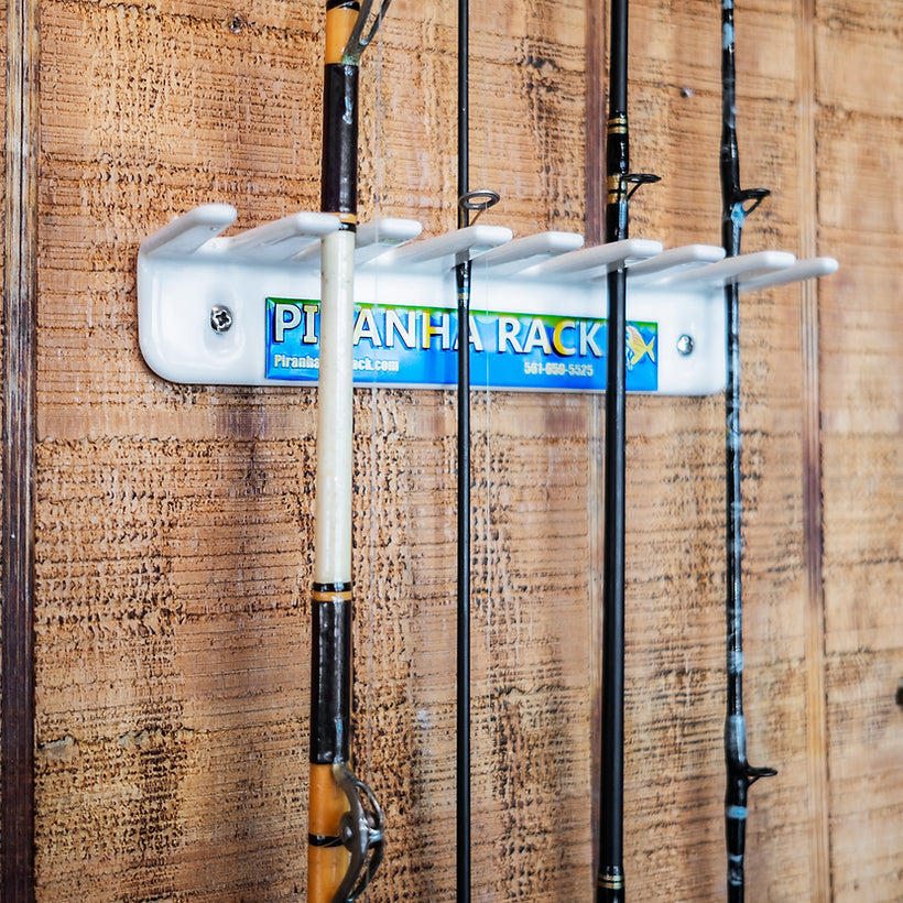 White wall-mounted Piranha Rod Rack holding fishing rods